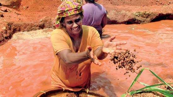 Women step into a man’s world   Females take to  gem  mining in  search of fortune