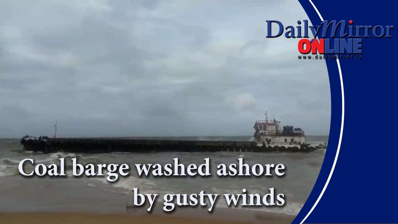 Coal barge washed ashore by gusty winds