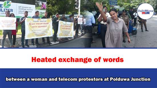 Heated exchange of words between a woman and telecom protestors at Polduwa Junction