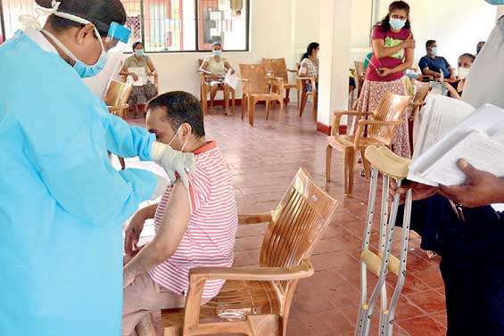 A Physically challenged person is being given the COVID-19 vaccine