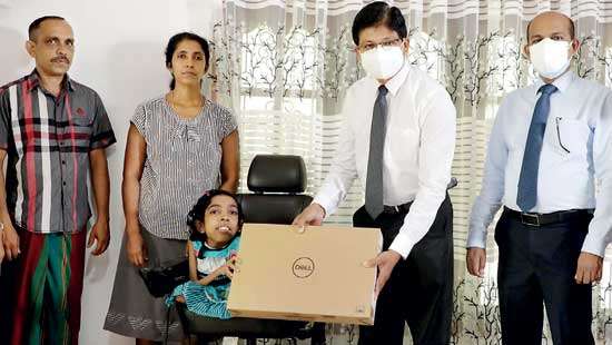 PB presents laptop to differently-abled student for outstanding O/L results