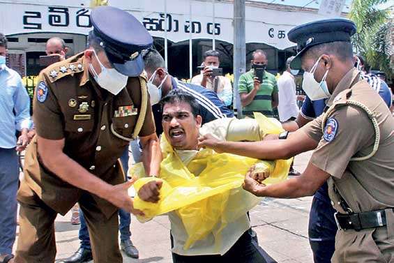 Police drag members of the Self  Employees Association who protested in Pettah.