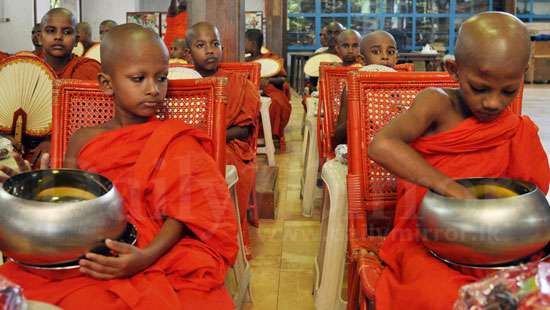 Novice monk examines the alms bowl