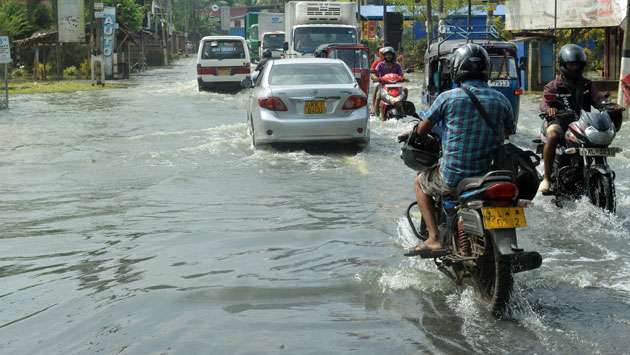 Residents, vehicles struggle on flooded