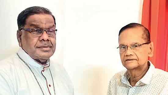 G.L. Peiris presents book on ‘peace process’ to Bishop of Jaffna