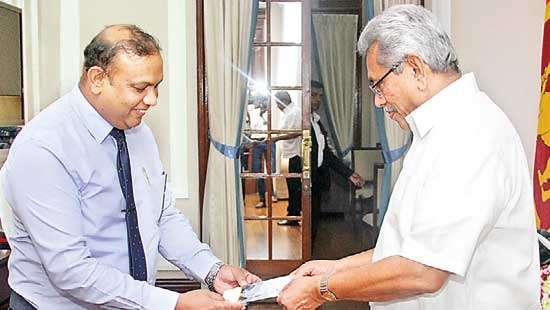 Dr. Asela presents books to President