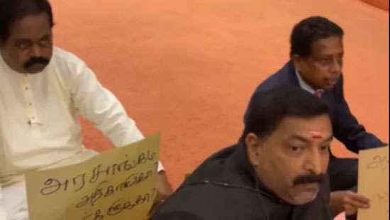 Opposition MPs representing plantation sector stage protest in Parliament