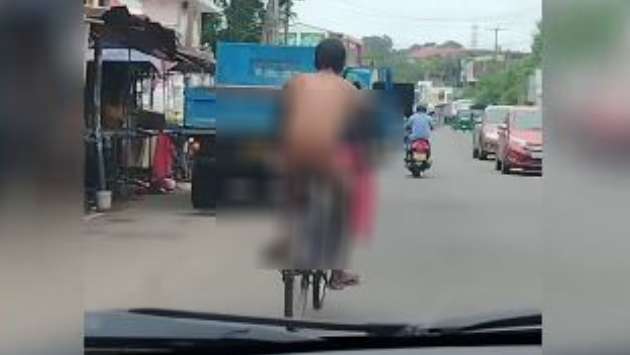 Naked man caught on camera riding bicycle through Kandana town
