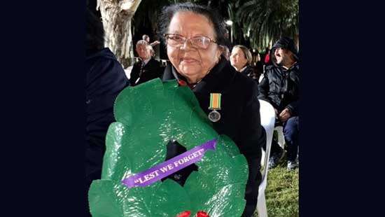 Felicitas Appathurai places wreath representing SL Community