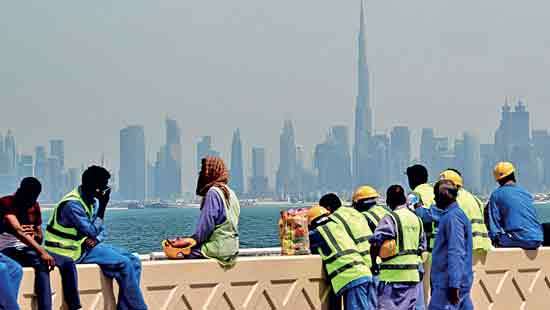 The two faces of Dubai:  Glitzy high-rises, low-paid workers