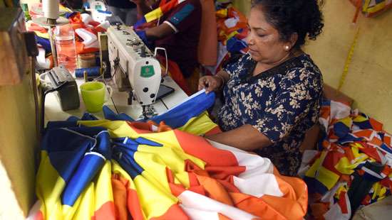 Stitching Buddhist flags...