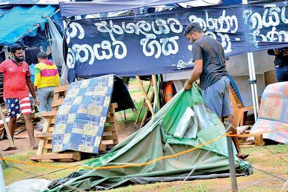 Protesters remove tents put up at Galle Face