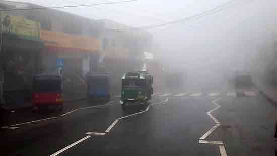 Thick fog envelopes hills in Uva