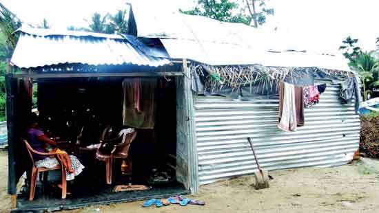 House Hit by Sea and Family by Bureaucracy