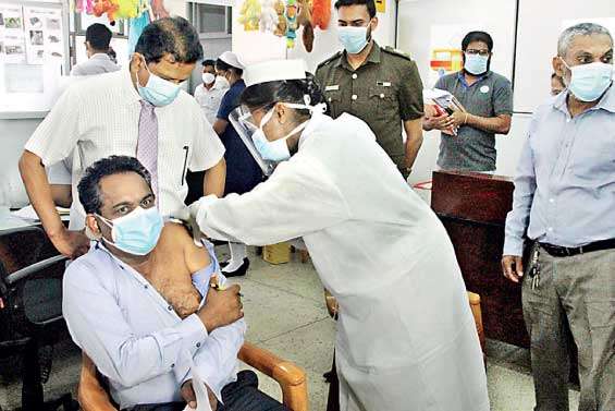 COVID-19 vaccine being administered to a Medical doctor