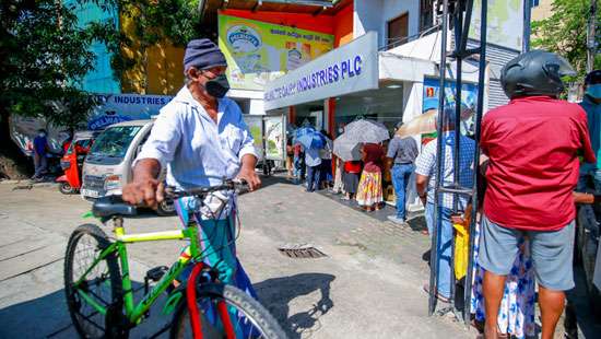 People languish in Long queues to buy milk powder…