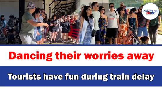 Dancing their worries away,Tourists have fun during train delay