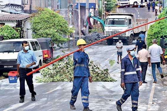 Debris from two gutted factories in Homagama litter the streets