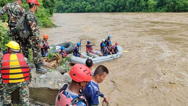 More than 60 people missing after two buses swept into river in Nepal