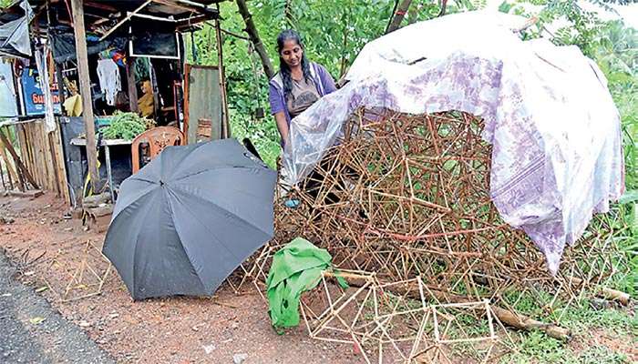 Vendor shields Vesak lanterns amid bad weather