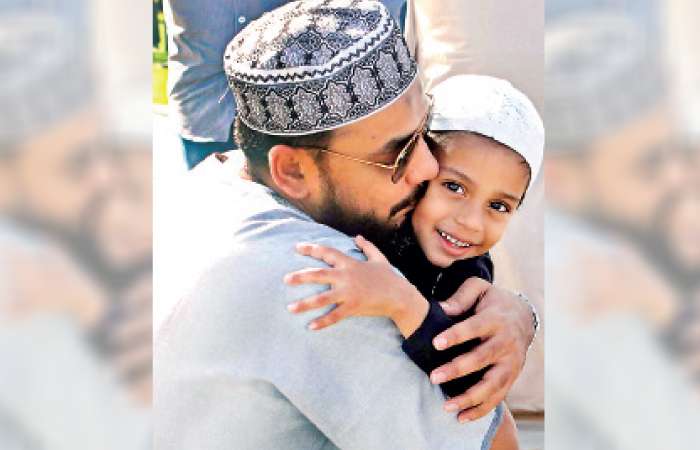 Father embraces child after Eid Ul Adha prayers