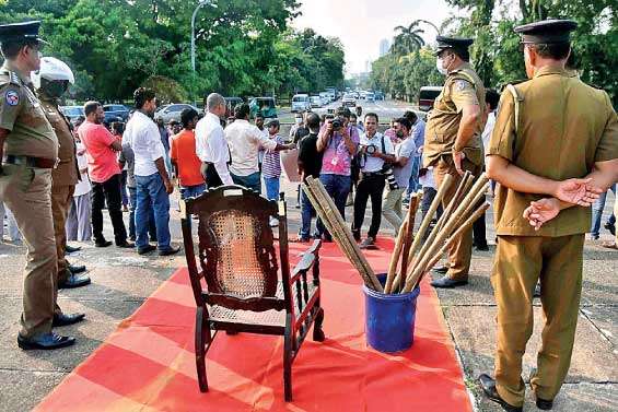 Police officers standing guard around a VIP chair kept