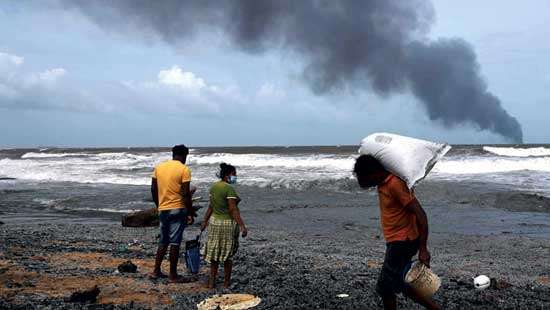 Negombo Police take action against shoreline scavengers Negombo coastline laid waste by burning ship