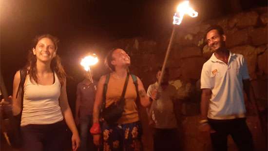 Tourists climb Mihintale with flaming torches