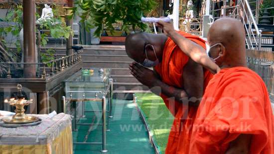 Oil anointing at Gangaramaya Temple