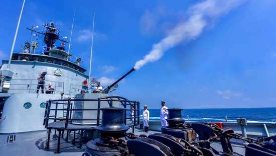 Naval gun battery booms on Independence Day