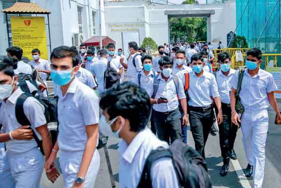 Students adhering to health guidelines arrive for A/L exams