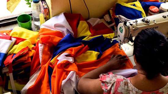 Stitching Buddhist flags...