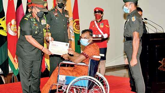 Army Commander General Shavendra Silva hands over cheque to disabled soldier