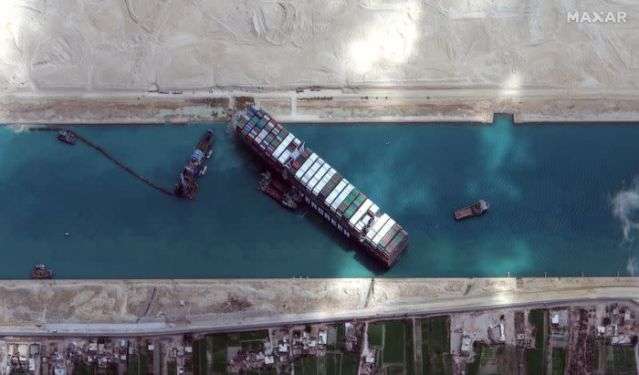 Diggers and dredgers struggle to free ship blocking Suez Canal