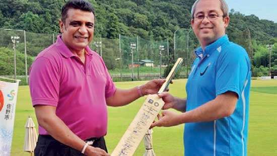 Autographed bat presented to Japanese Cricket Council Head