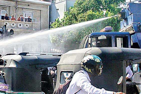 IUSF group seeking a meeting at UGC hindered Police show no mercy  as repeated water cannon attacks even affected bystanders