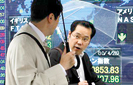 Asian shares hit by currency concerns, oil slump
