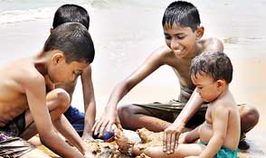 Children play on the Galle Face beach.