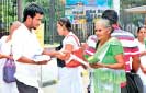 Sarvodaya Development Finance distributes religious booklets to devotees at Dalada Maligawa 