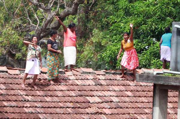 Female inmates protest on roof