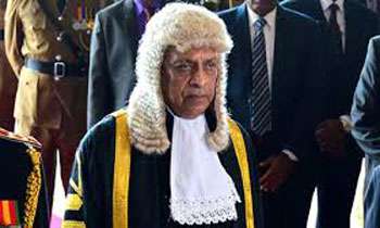 Speaker leaves seat after objects thrown at him